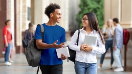 two young people walking and chatting