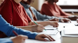 Close up on student's hands while they take their test