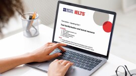 Close up girl in front of computer and screen shows IELTS information