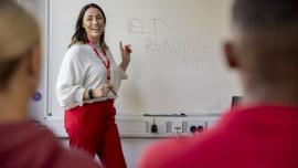 A skilled and experienced teacher guiding a student through an IELTS practice test for IELTS preparation